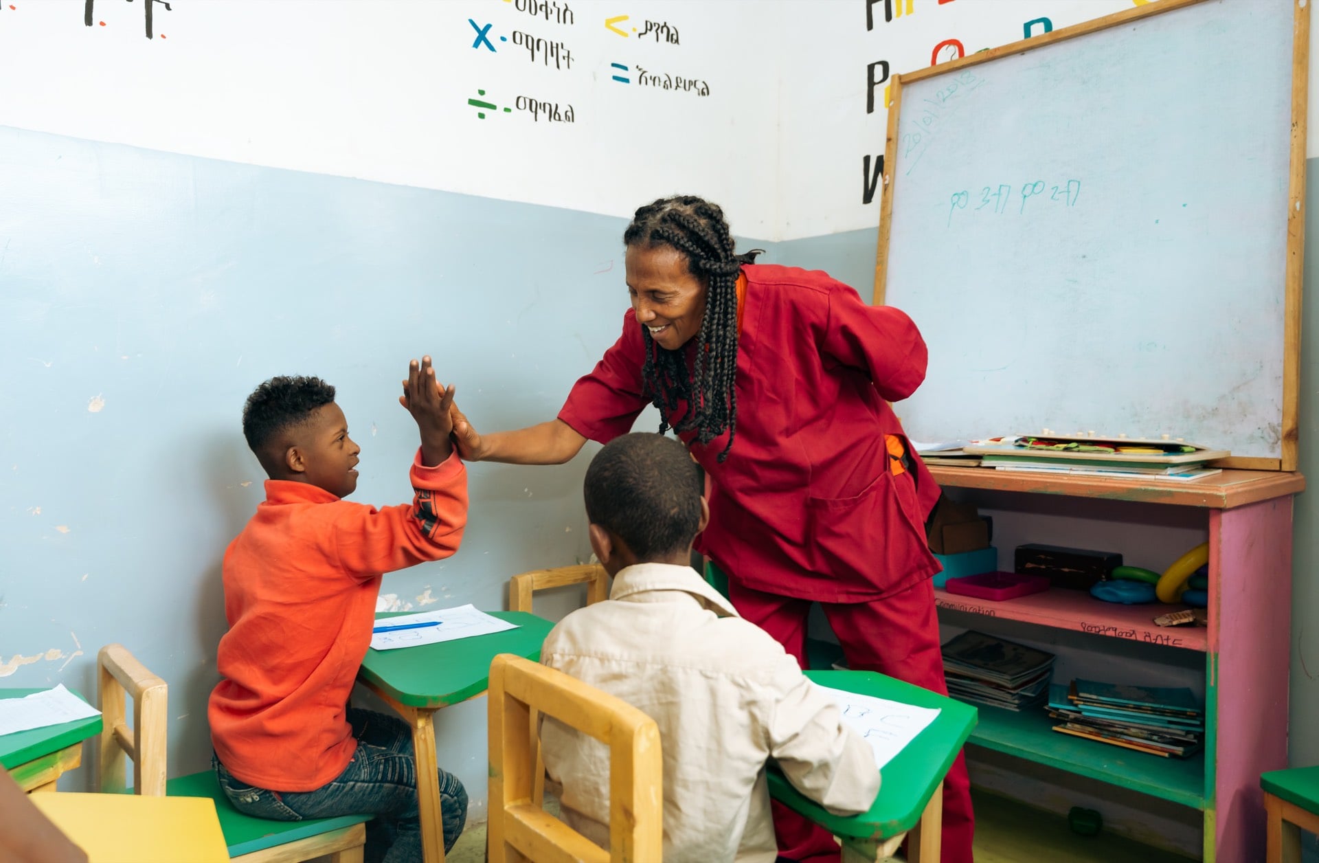 Teacher and student reaching for a high five